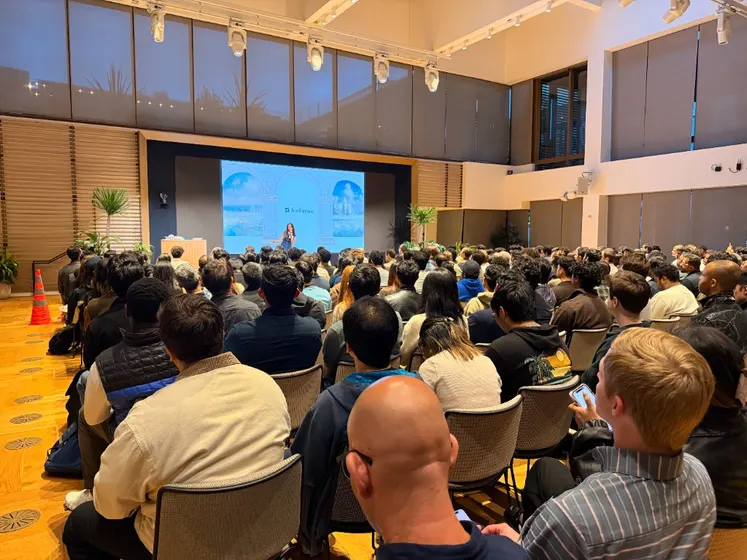A packed audience watching a talk on the Intelligence stage