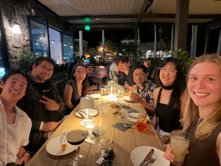 The team at dinner together outdoors at night
