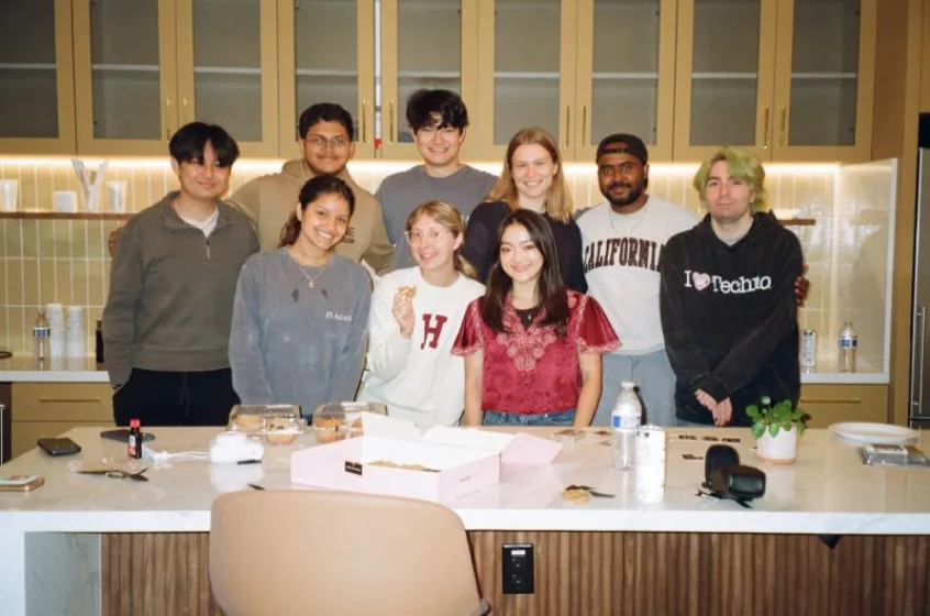 The team gathered around the office kitchen island