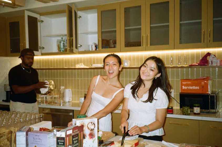 Two teammates preparing food in the office kitchen